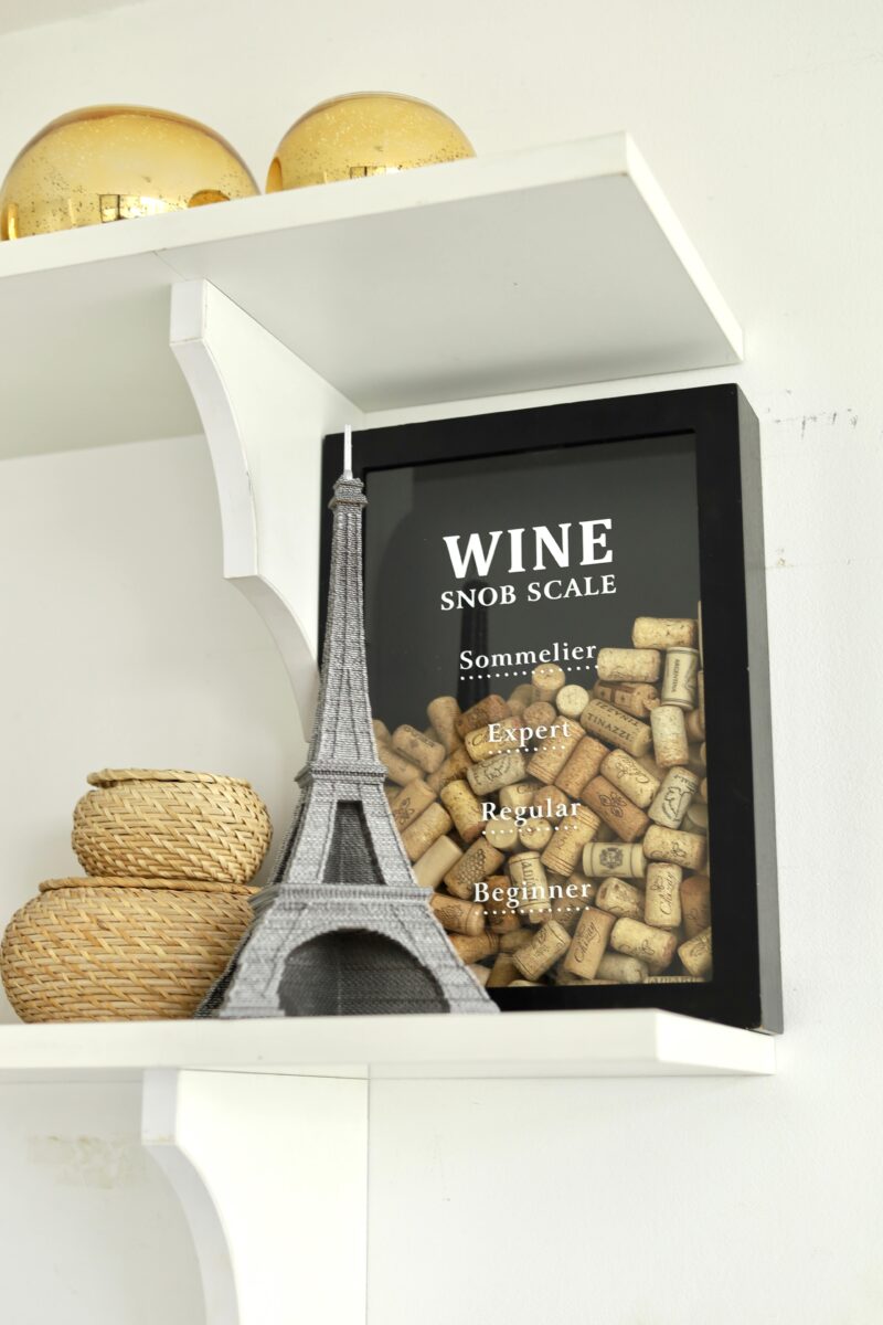 Completed Eiffel Tower Cartonic puzzle styled in a bookshelf, adding Parisian charm to the interior.