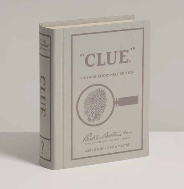 Elegant Clue Vintage Edition board game styled as a linen-bound book, with 1949-inspired graphics, metal weapons, wood tokens, and vintage clue cards.