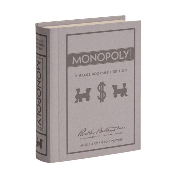 Elegant Monopoly Vintage Edition board game with linen book box, pewter tokens, wooden houses and vintage cards, styled for bookshelf display.