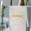 Champagne gift set in beige and orange book-style box with stainless steel opener and stopper – stylish gift