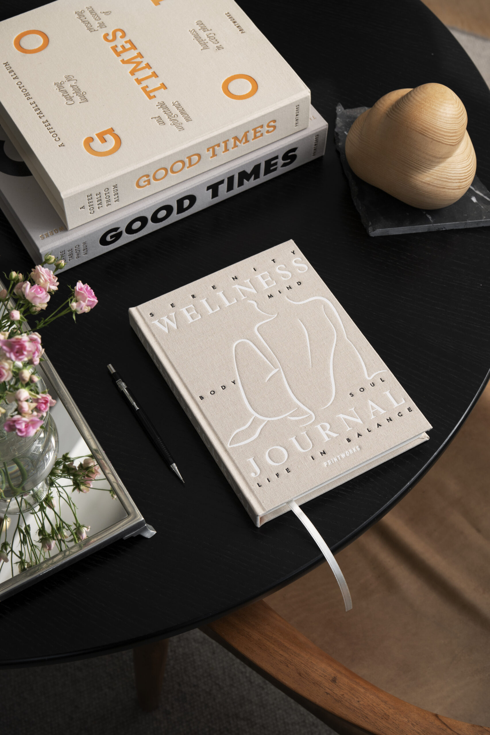 welness journal on table with books