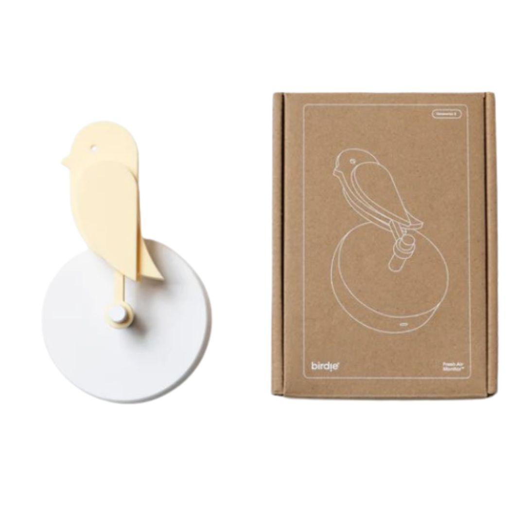 Birdie 2.0 indoor air quality monitor in Dune soft yellow mounted on wall