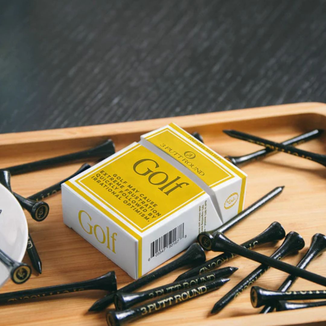 A gold golf tees pack with attitude — compact, playful and made for those who take their game (and style) seriously.